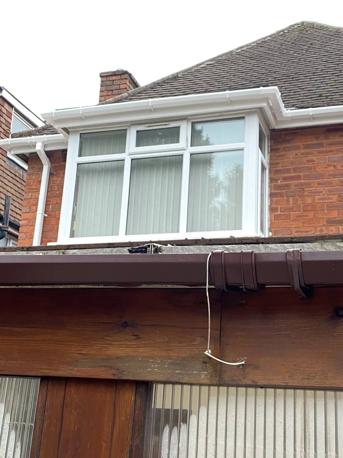 New white fascia and gutter above a bay window